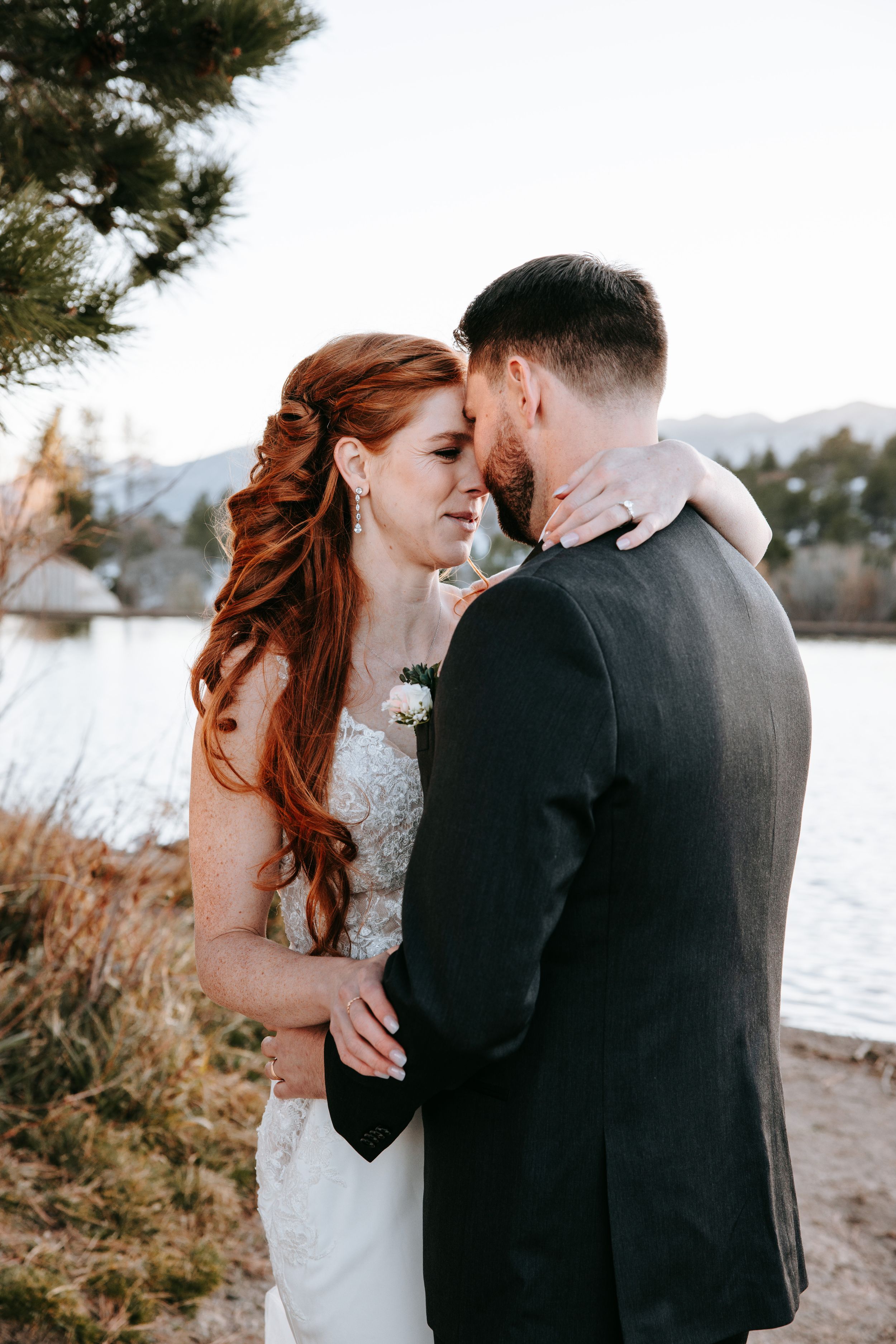 A romantic winter wedding photo series captured on a snowy beach with intimate moments between newlyweds.