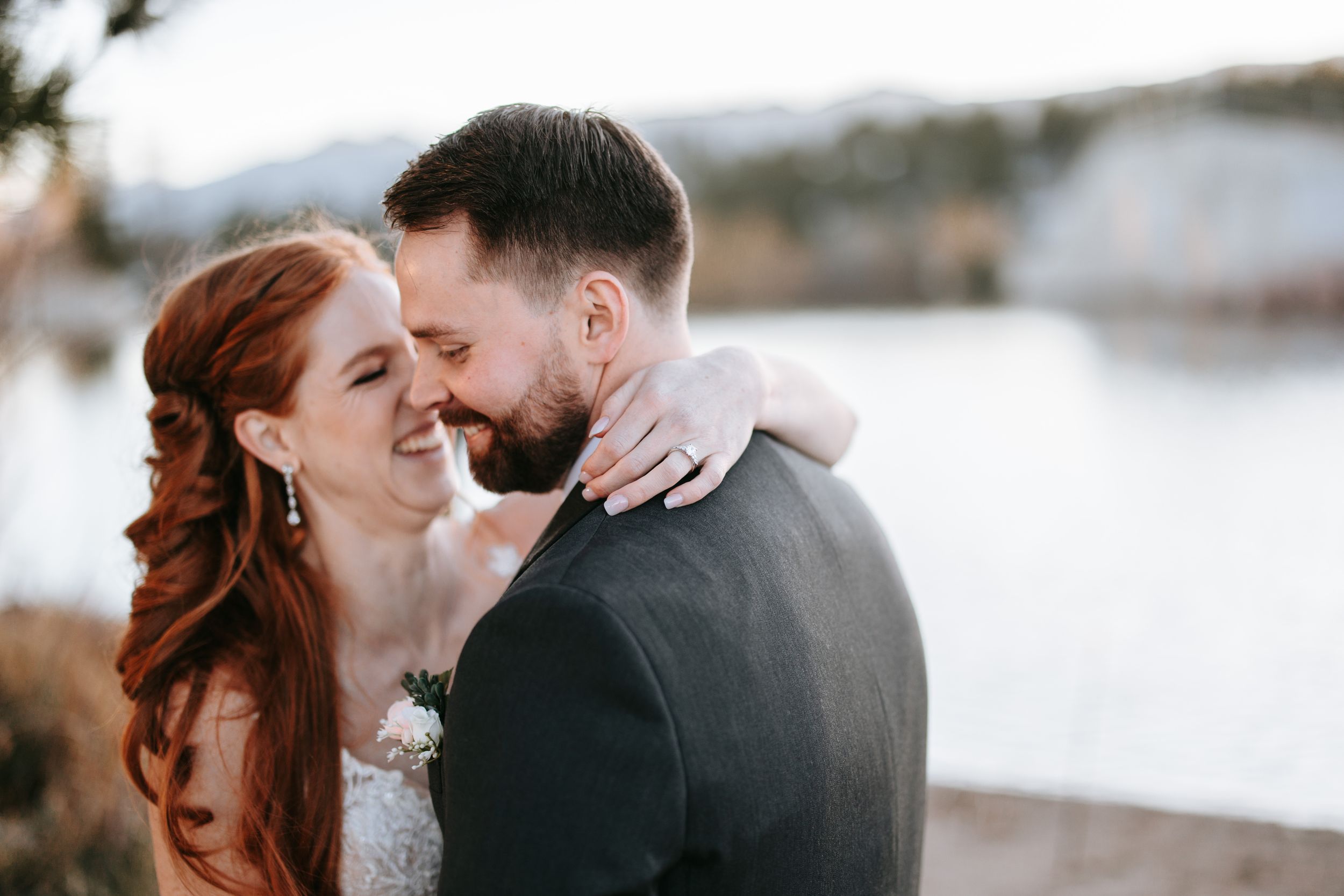 Intimate wedding portrait against snowy winter background.