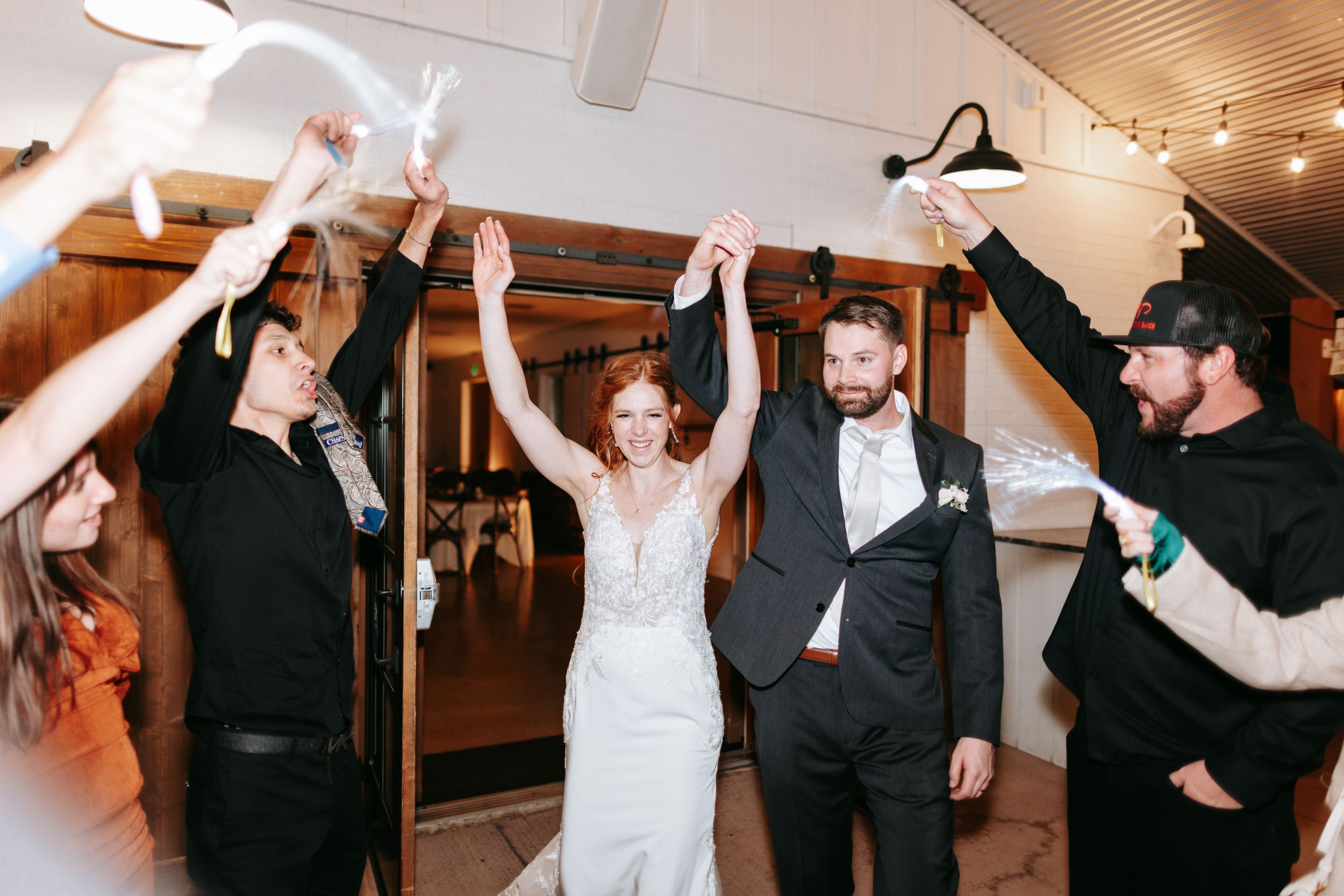 Celebration scene of party guests waving white napkins during dance at an indoor reception.