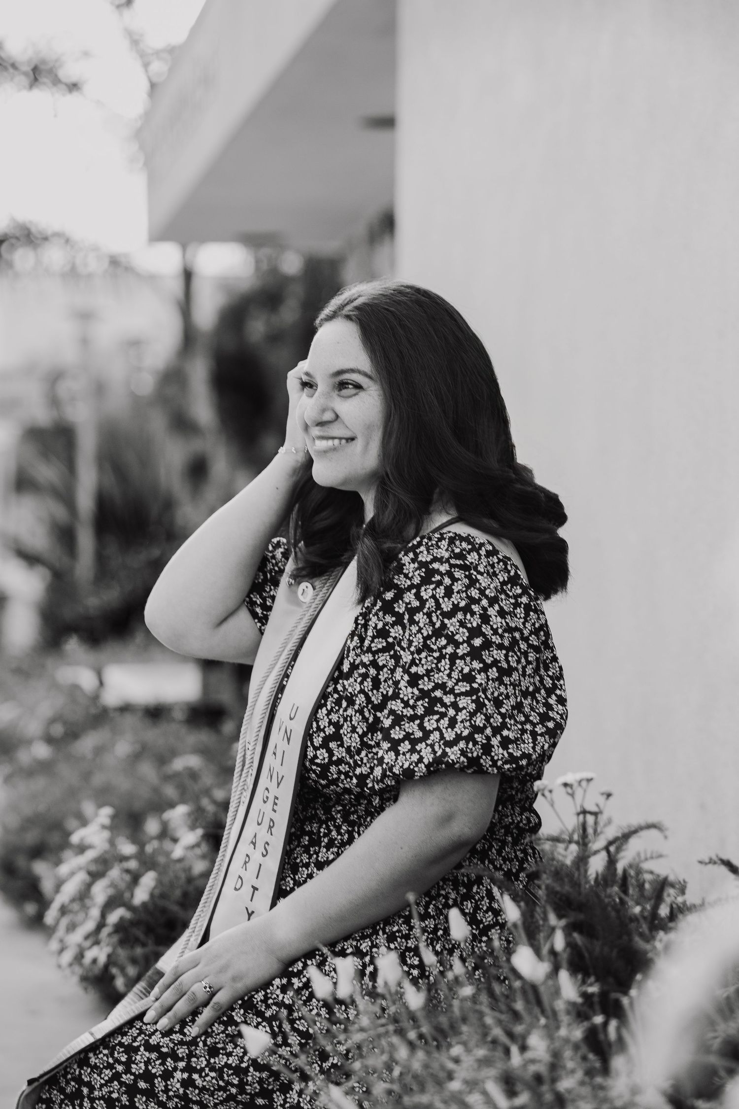 Black and white portraits showing joyful expressions among garden flowers.
