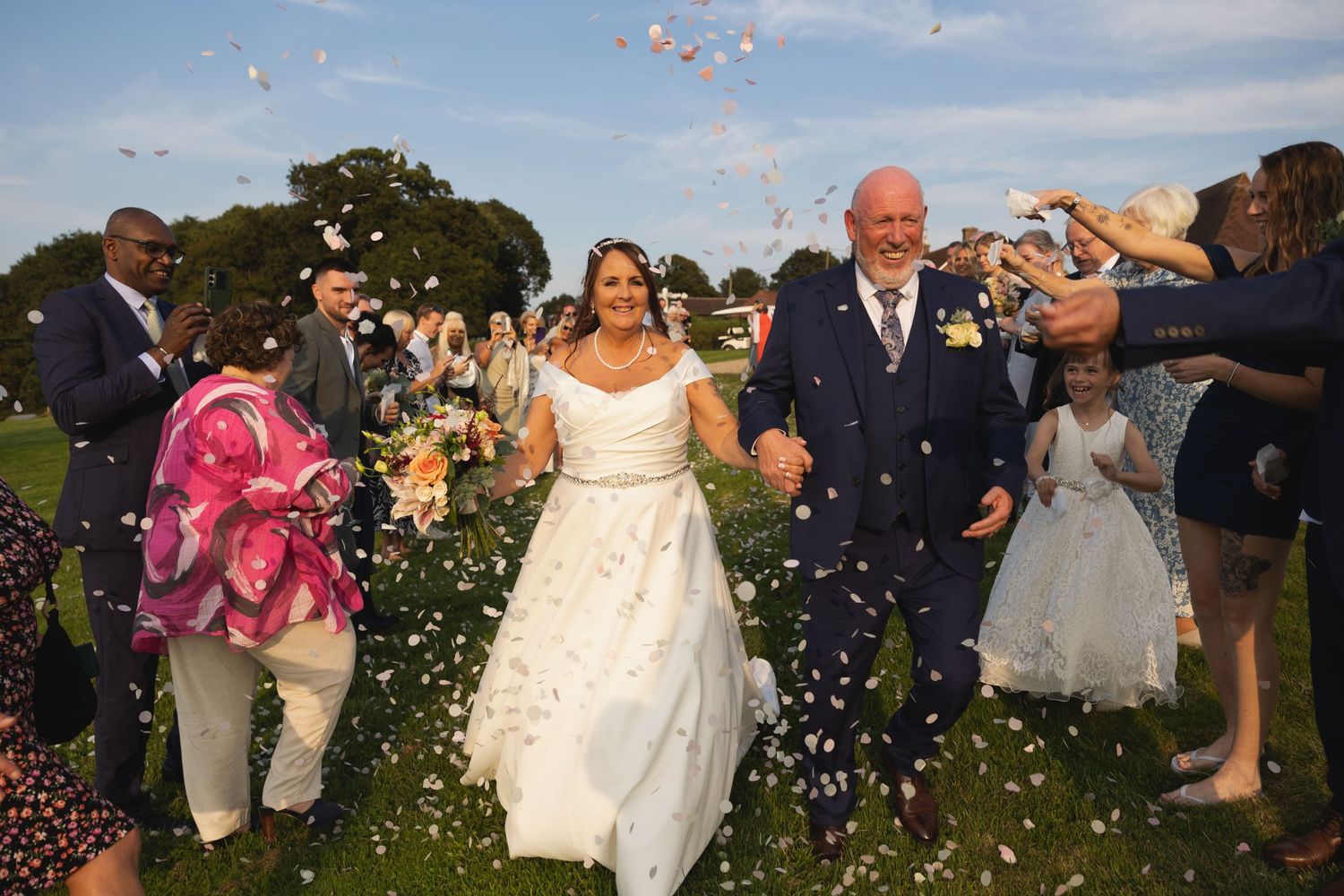 Wedding couple in confetti tunnel Blackstock Estate