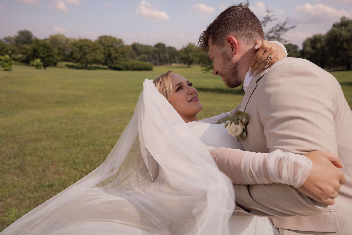 A romantic outdoor wedding photoshoot series showing the couple together in a rolling green field at sunset.