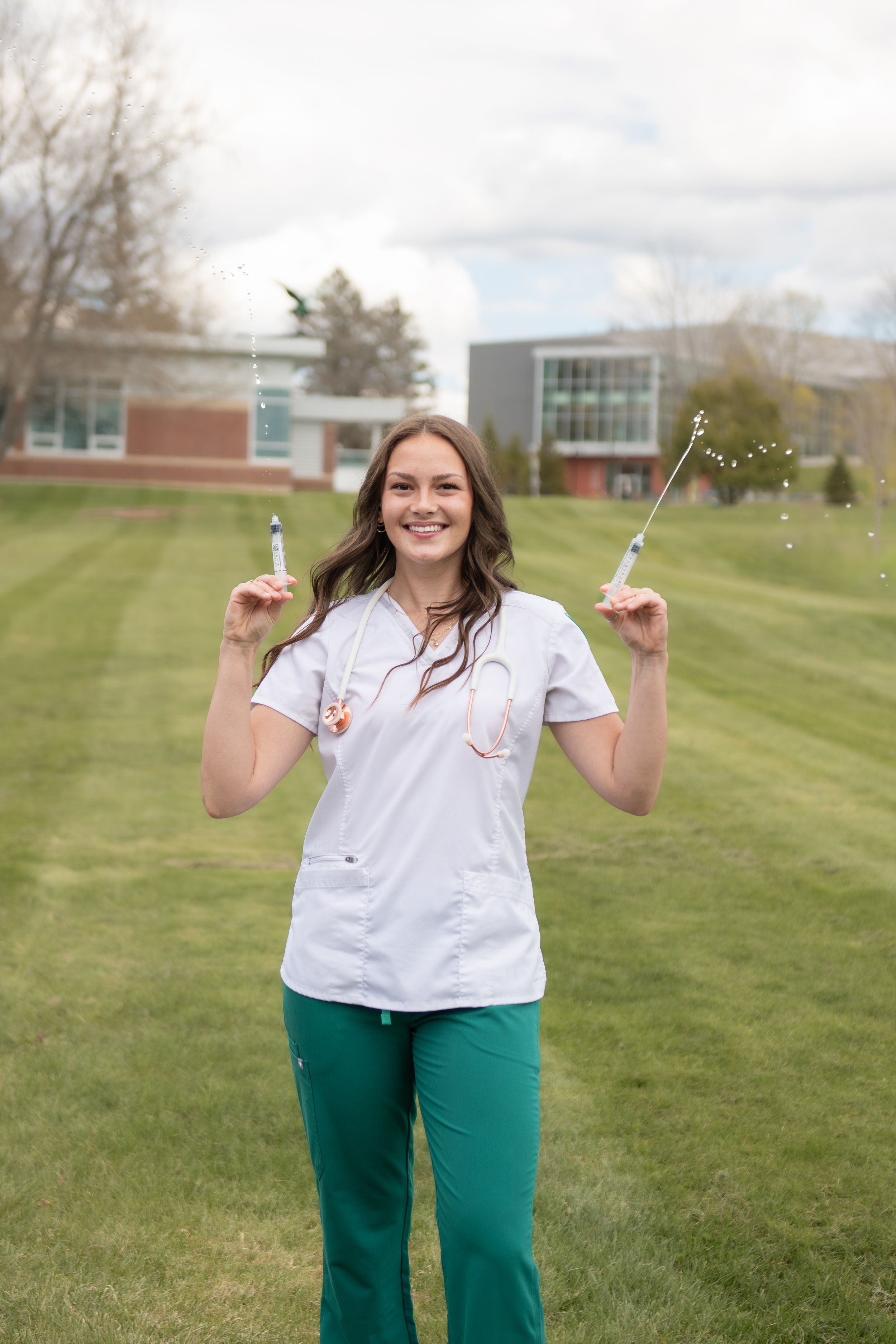 Graduation photo shoot with cap and gown, on campus at Umaine, near orono, maine; Nursing Graduation Photos; Central Maine Photo