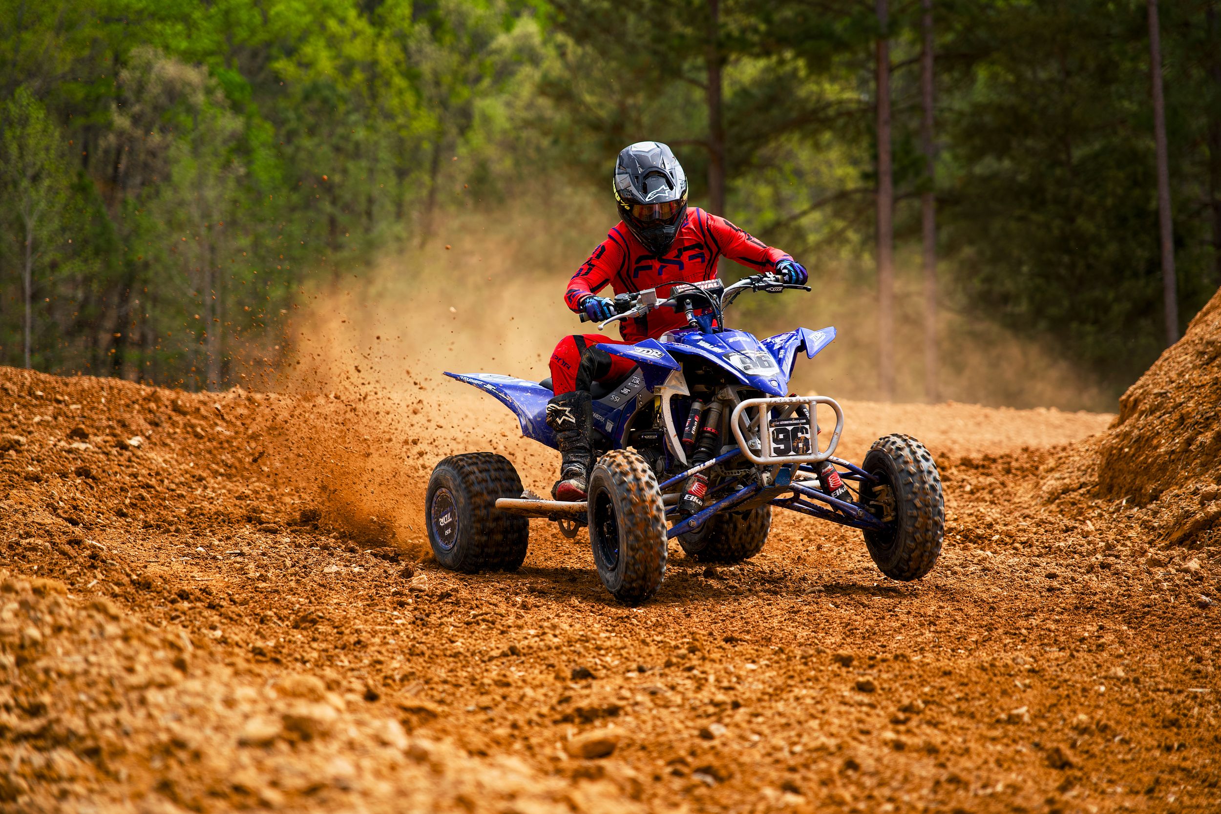Blue ATV launching out of a corner