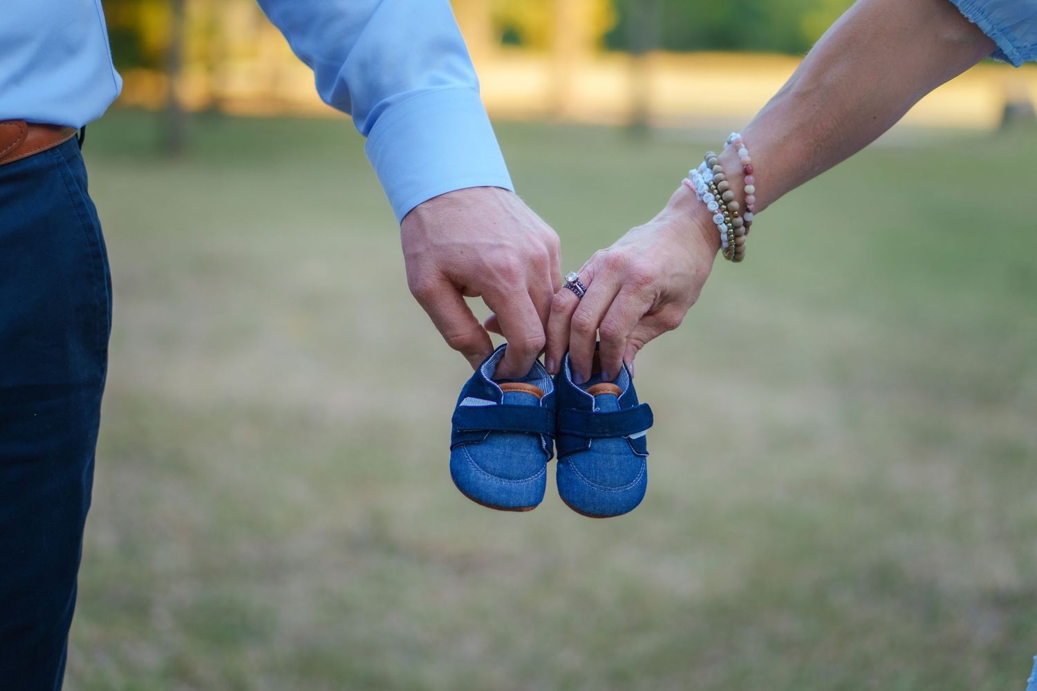 maternity creative shot announcement baby boy Keller town center Texas blue shoes mom dad love siblings photoshoot mom to be expecting