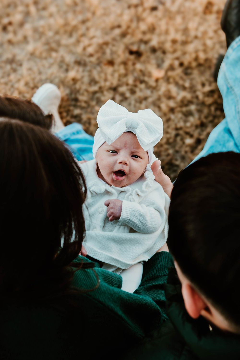 Close-up sequence showing a small baby in white clothing being held.