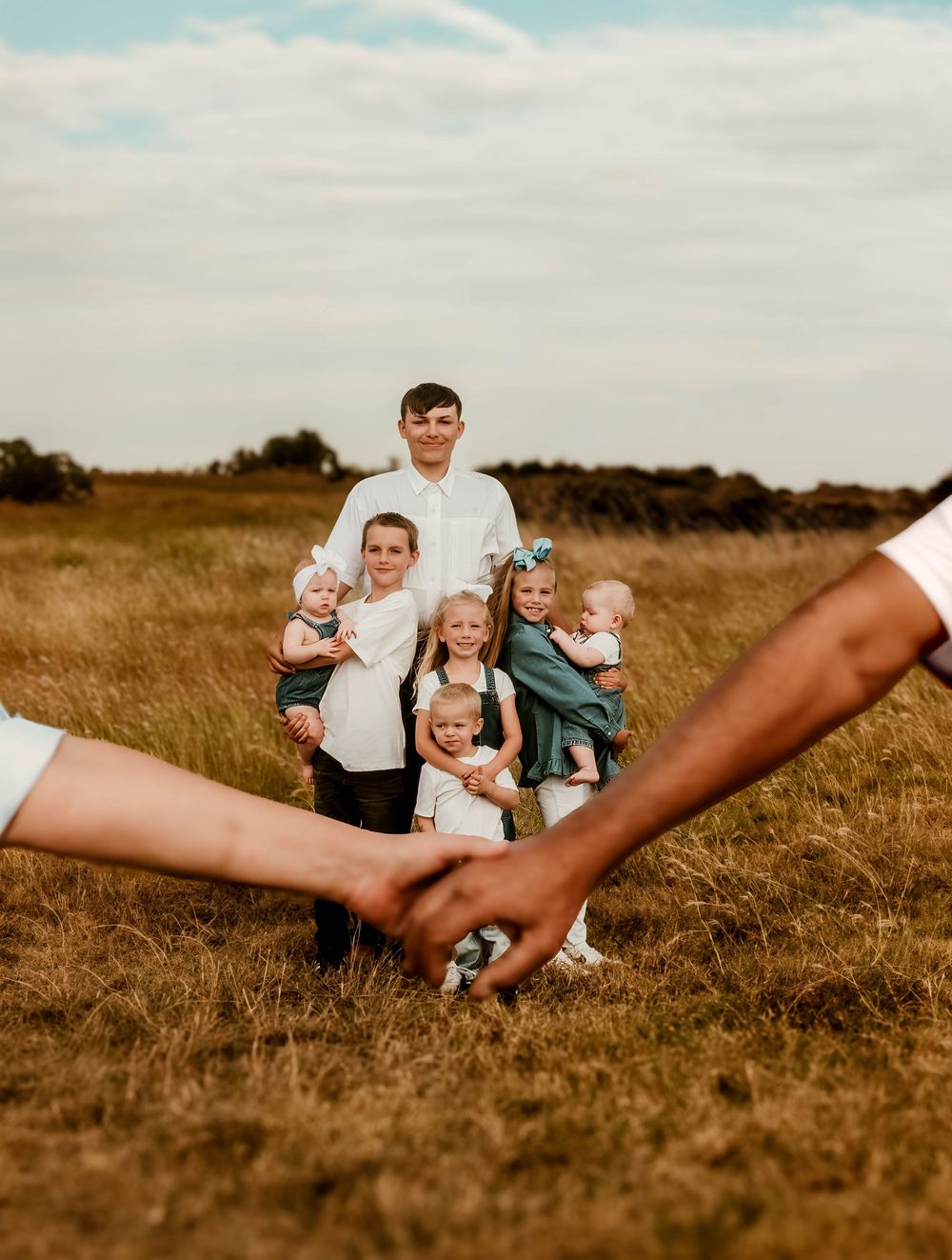 Family photo sequence in a golden field showing playful interactions and poses.
