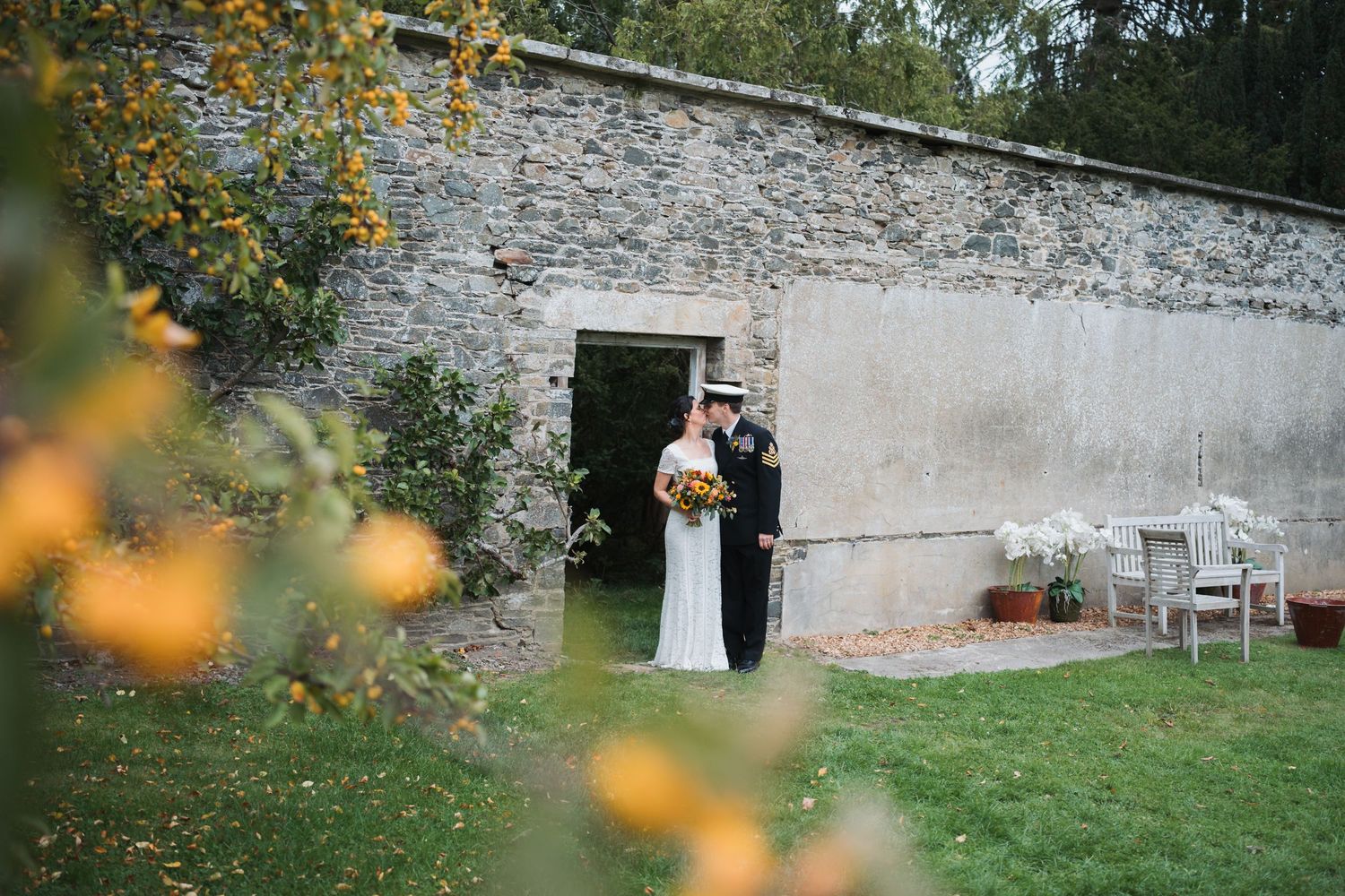 bride and groom on jetty at loch awe in scotland