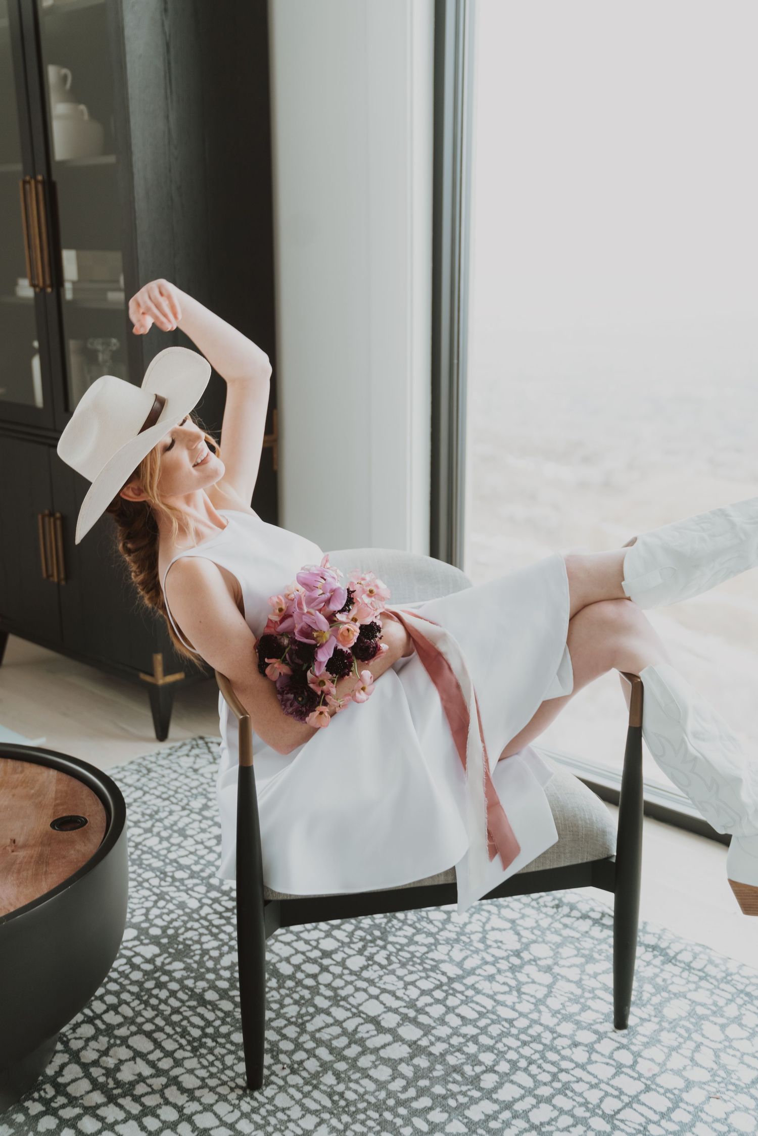 Artistic bridal portrait series showing movement in a white dress against patterned carpet.