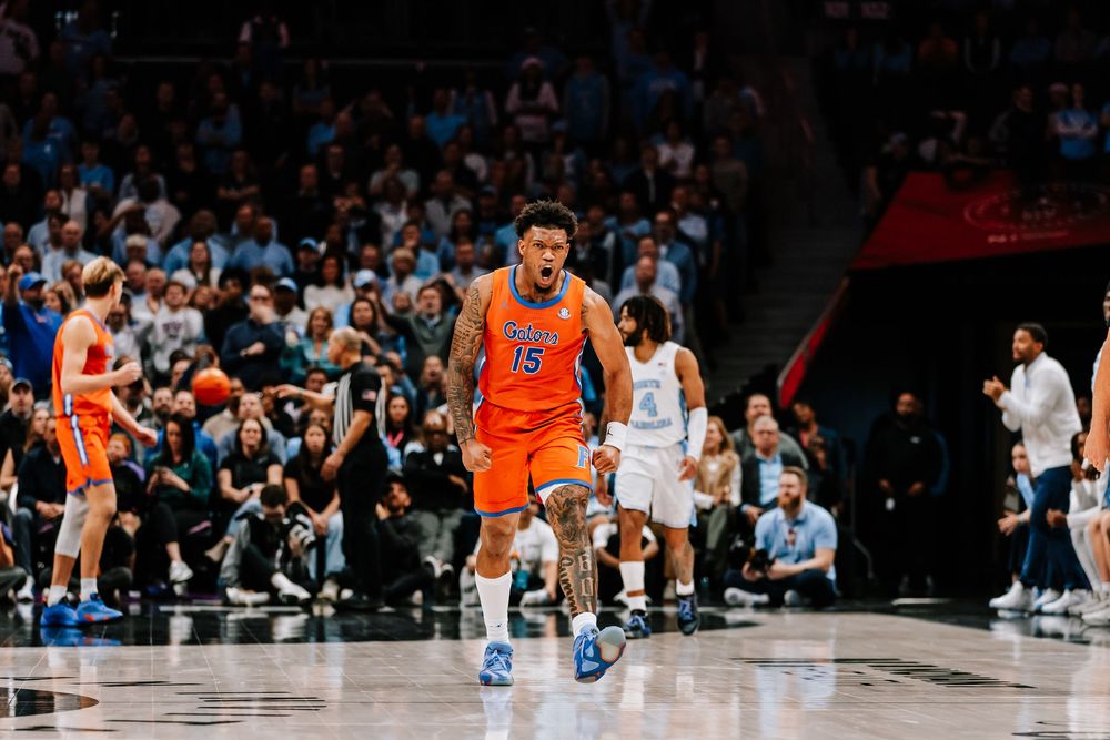 Florida Gators player #3 celebrates intensely in orange uniform during college basketball game.