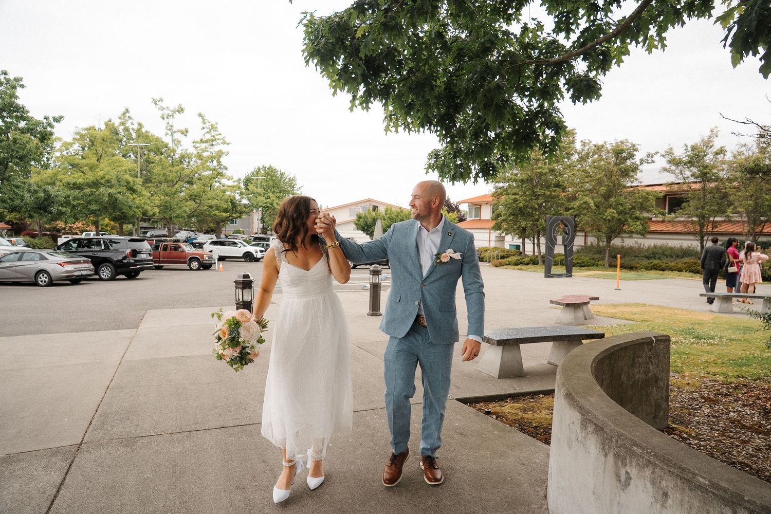 A series of five consecutive photos showing a couple walking together outdoors along a paved pathway on a sunny day.