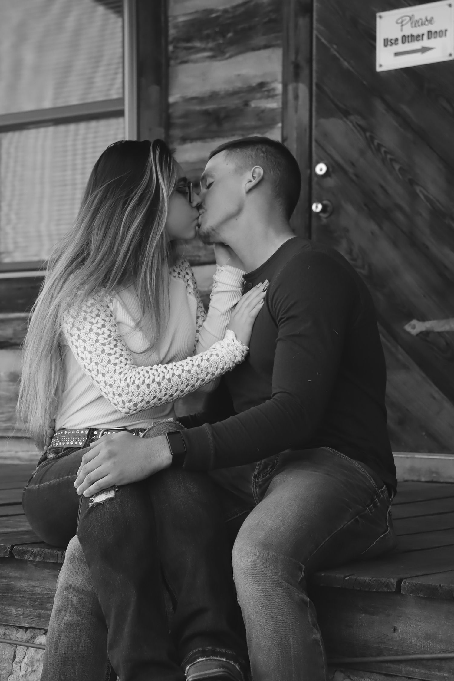 Black and white photo series of couple sharing intimate moments on wooden steps.