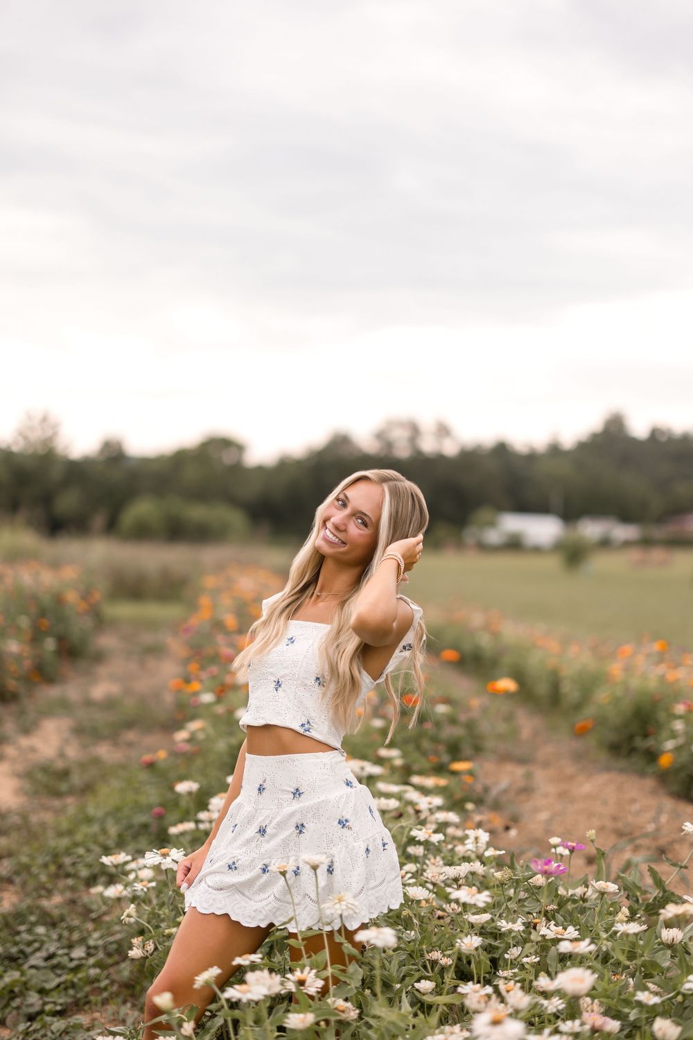 Joyful summer portrait session amidst blooming wildflowers and daisies in a natural meadow setting.