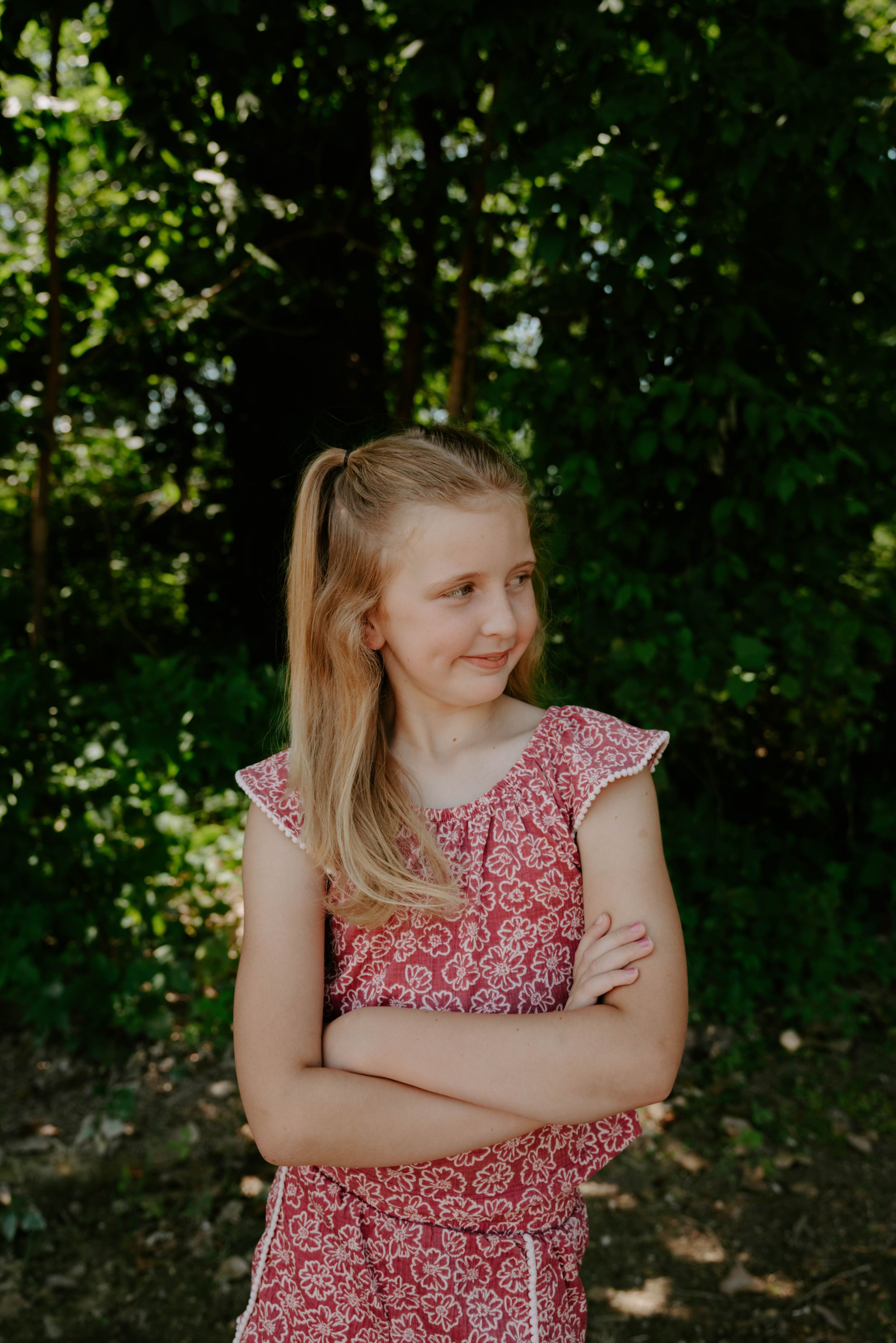 A summer portrait taken in a shaded garden setting with lush green foliage.