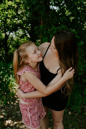 Candid moments of affection captured in a lush garden setting.