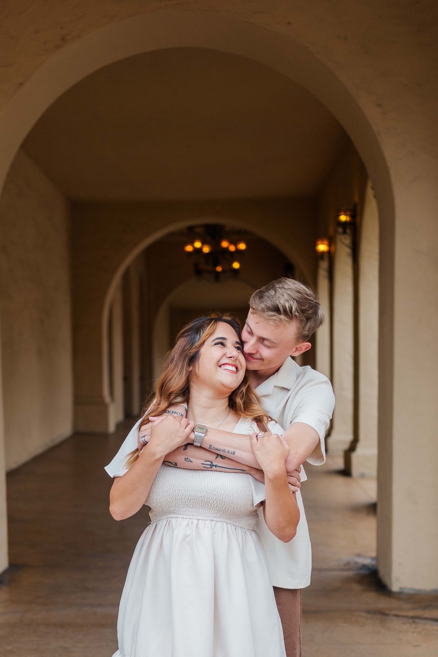A progressive sequence shows a couple sharing sweet kisses under an elegant archway corridor.