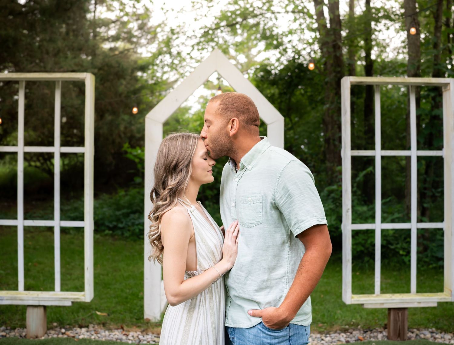 Romantic outdoor scene with white architectural elements and garden landscaping.