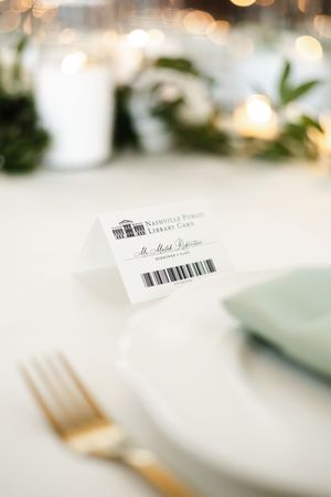 Close-up view of blurred white gift cards with barcode details against a soft bokeh background.