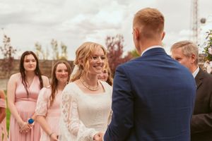 A small wedding celebration in progress with everyone appearing to dance and laugh together on the dance floor.