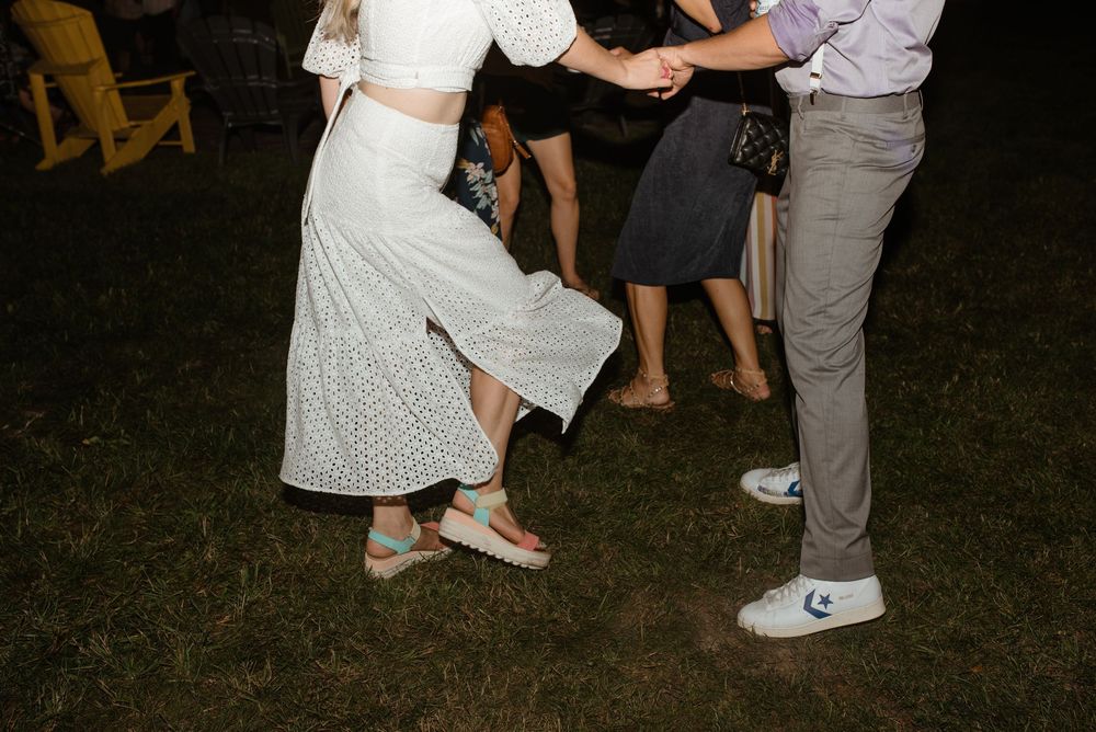 People dancing and having fun at a nighttime outdoor celebration event.