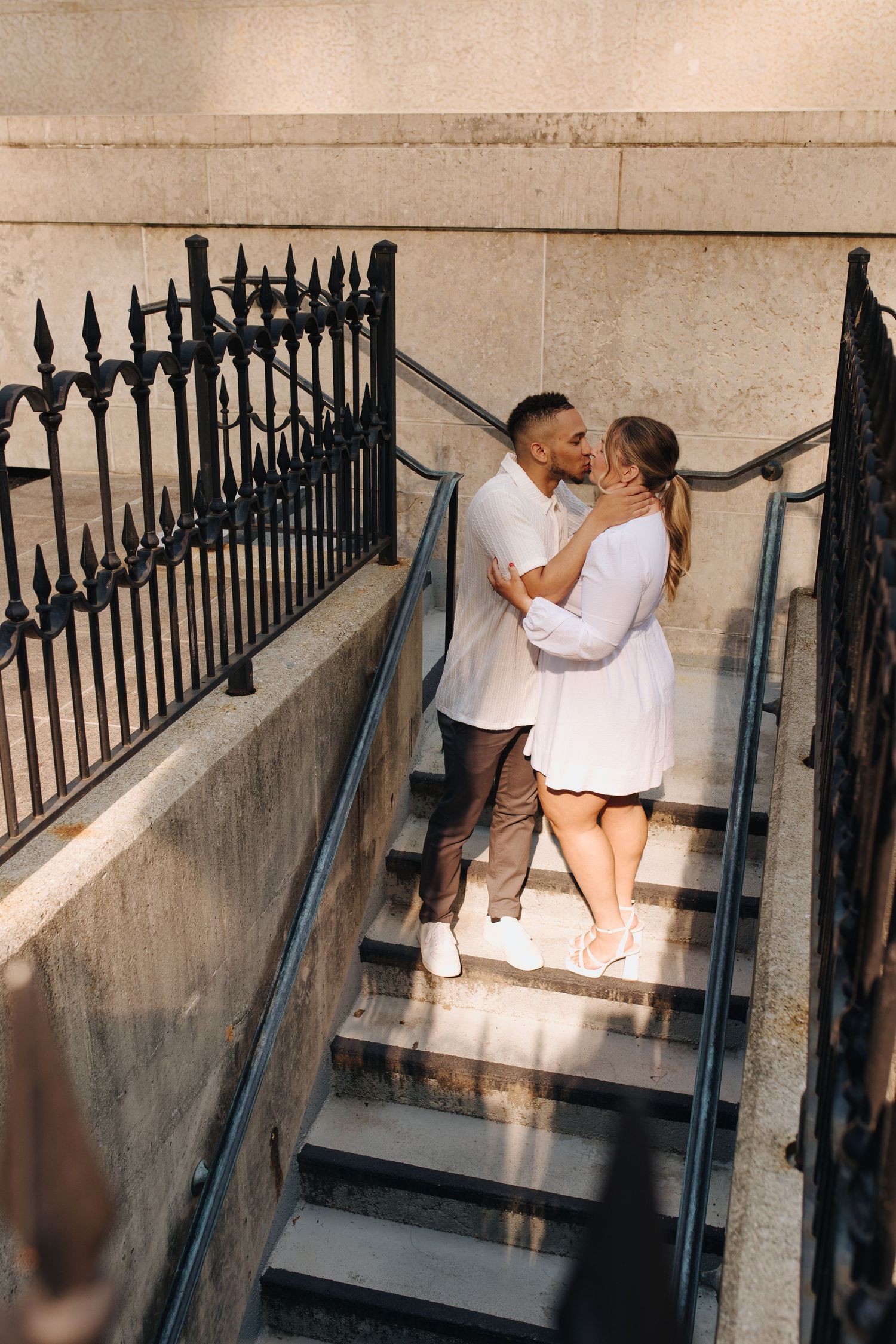 Timeless engagement photo of couple kissing on the Ohio Statehouse steps.