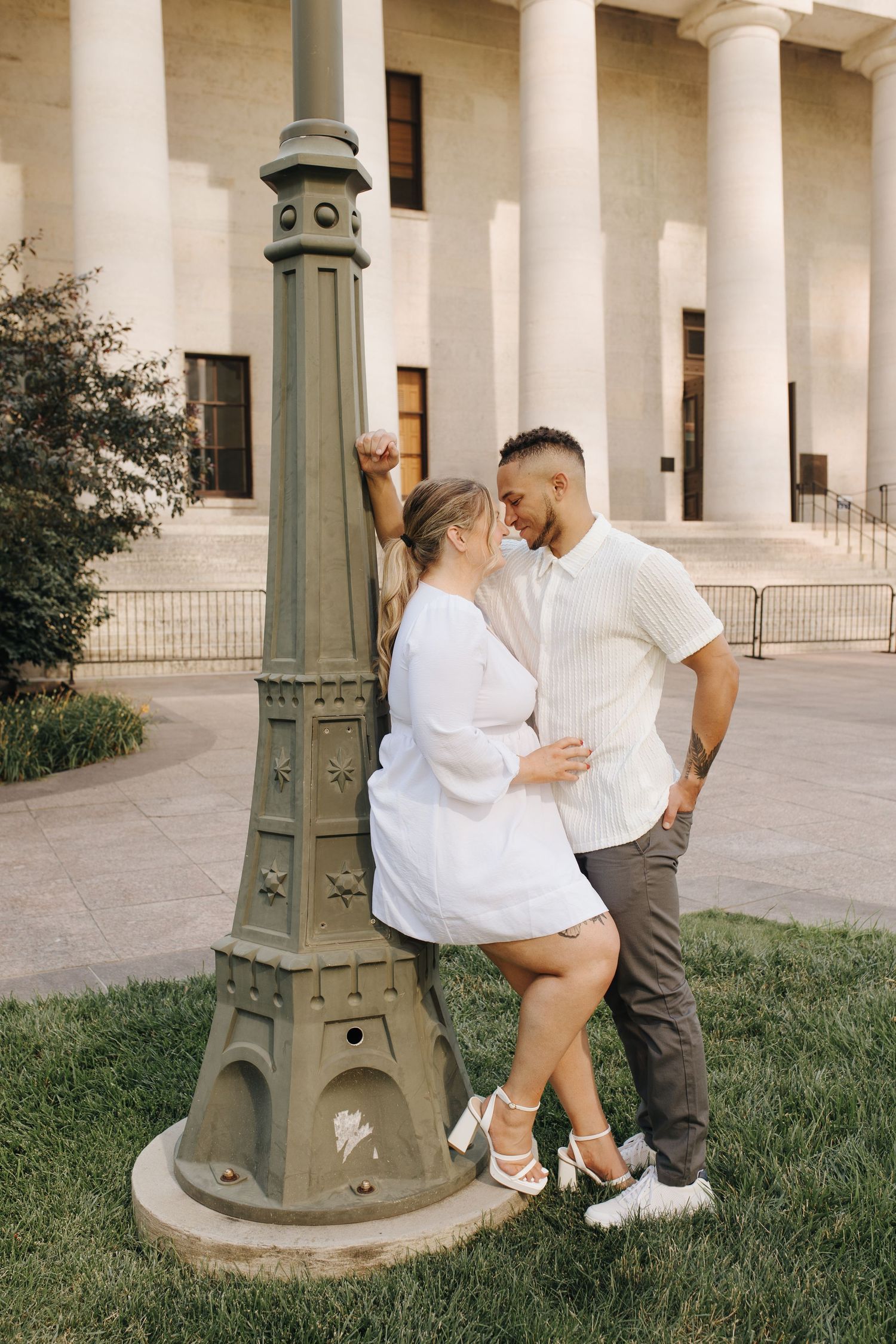 Jamie and Jacob leaning against vintage-style lamp on the Statehouse lawn in downtown Columbus.