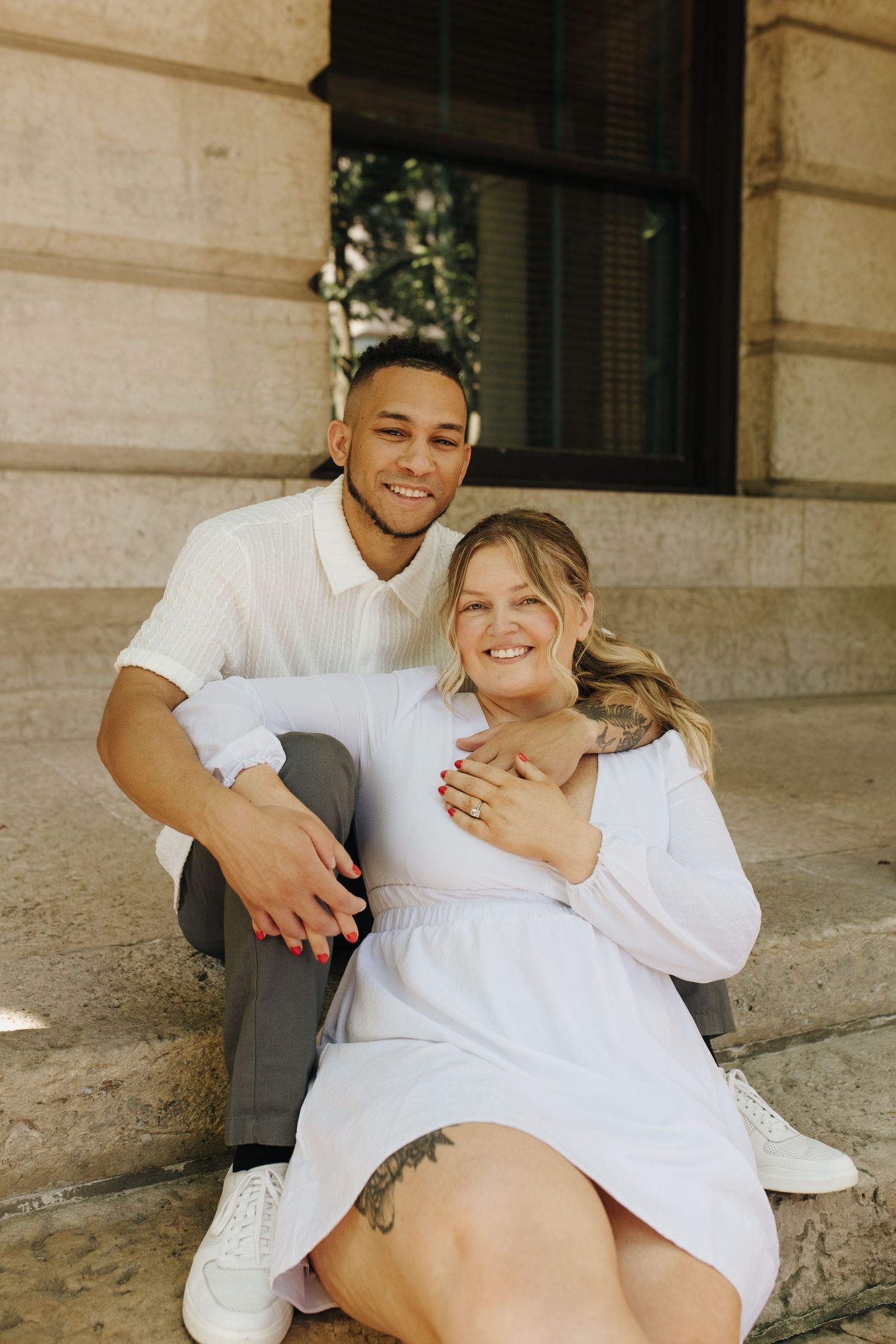 Timeless photo of Jamie and Jacob sitting on steps around the iconic Ohio Statehouse in downtown Columbus.