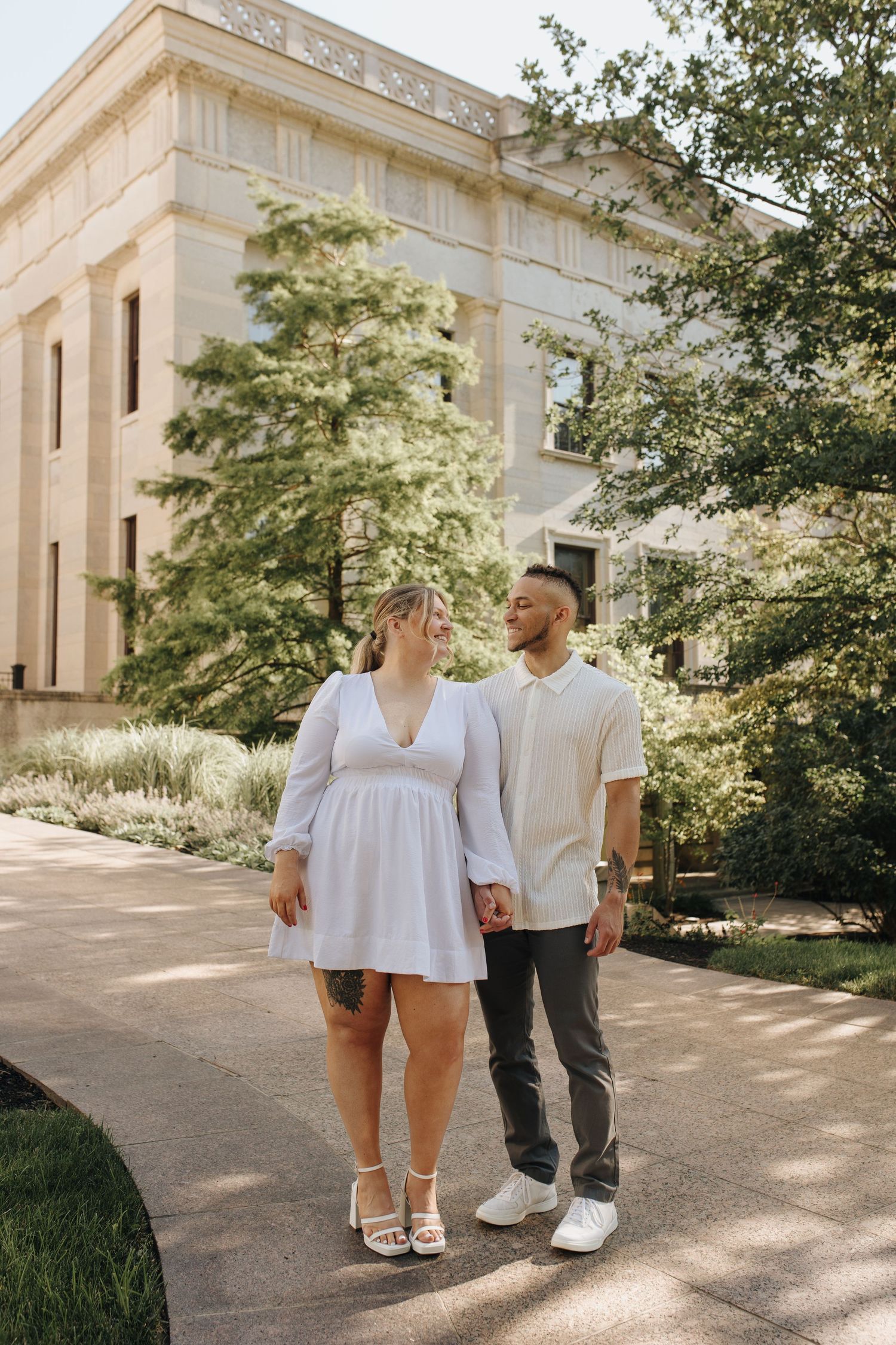 Engaged couple laughing together outside downtown Ohio Statehouse.