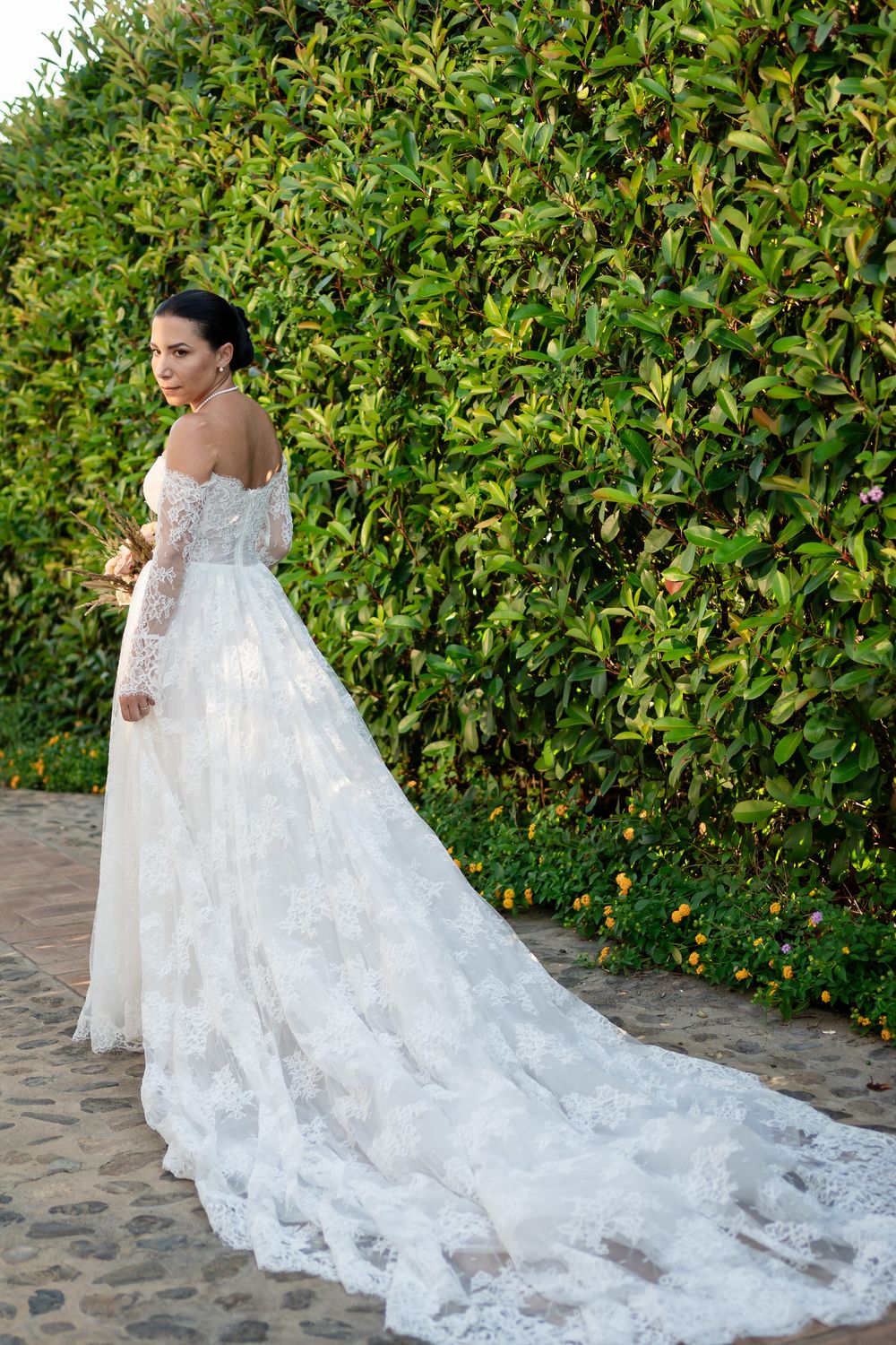 Bridal portrait series showcasing detailed lace wedding gown with cathedral train.