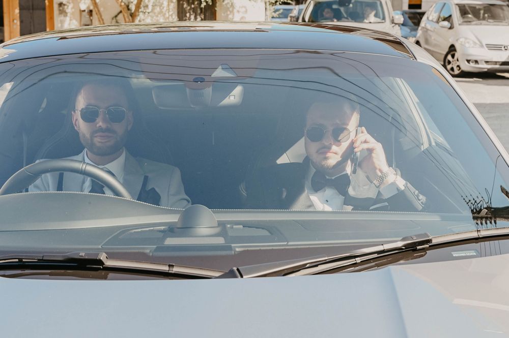 People sit in cars while stopped in a traffic jam or parking lot on a sunny day.