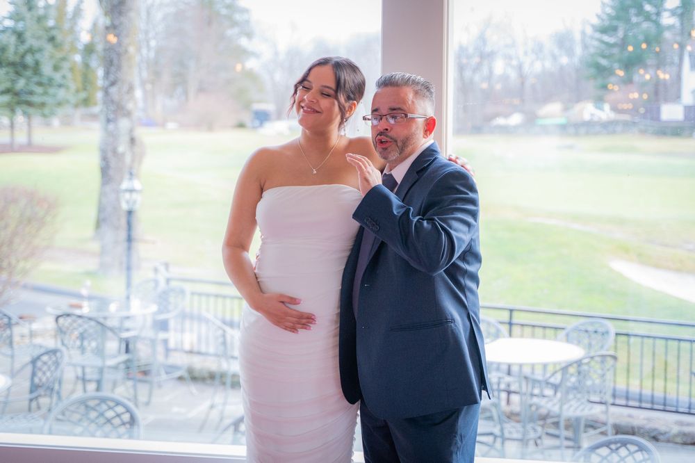 A happy couple shares a tender emotional moment together on their wedding day on a covered porch overlooking a garden.