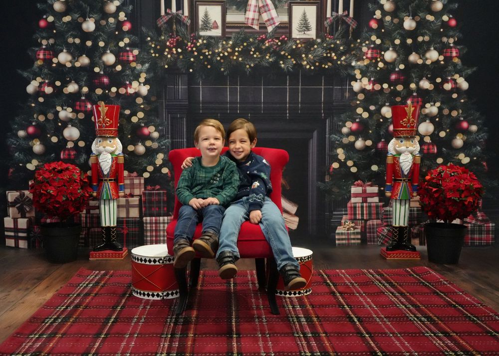 Festive Christmas scene with plaid blanket, decorated tree, wrapped presents and glowing string lights.