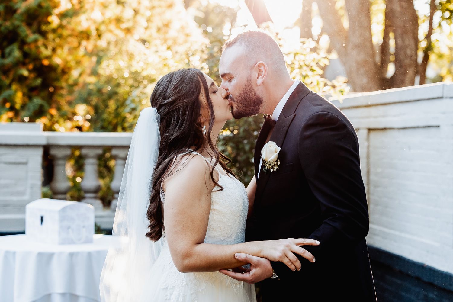 Couple sharing romantic moment during outdoor wedding ceremony.