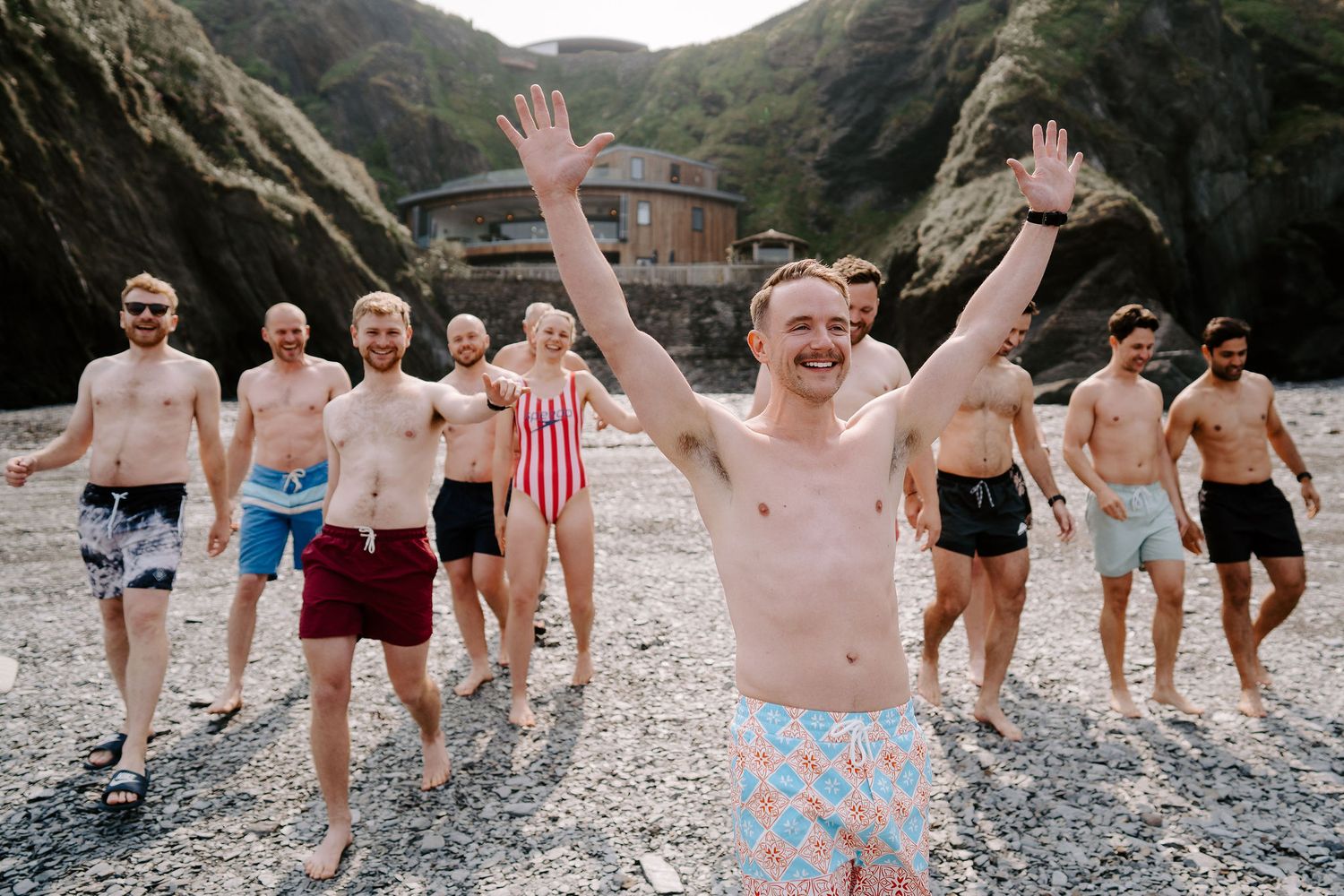 Groomsmen on morning of the wedding at tunnels beach wedding venue in north Devon, preparing for a morning swim