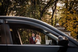 bride and groom framed by the car window