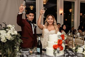 couple cheers after cake cutting