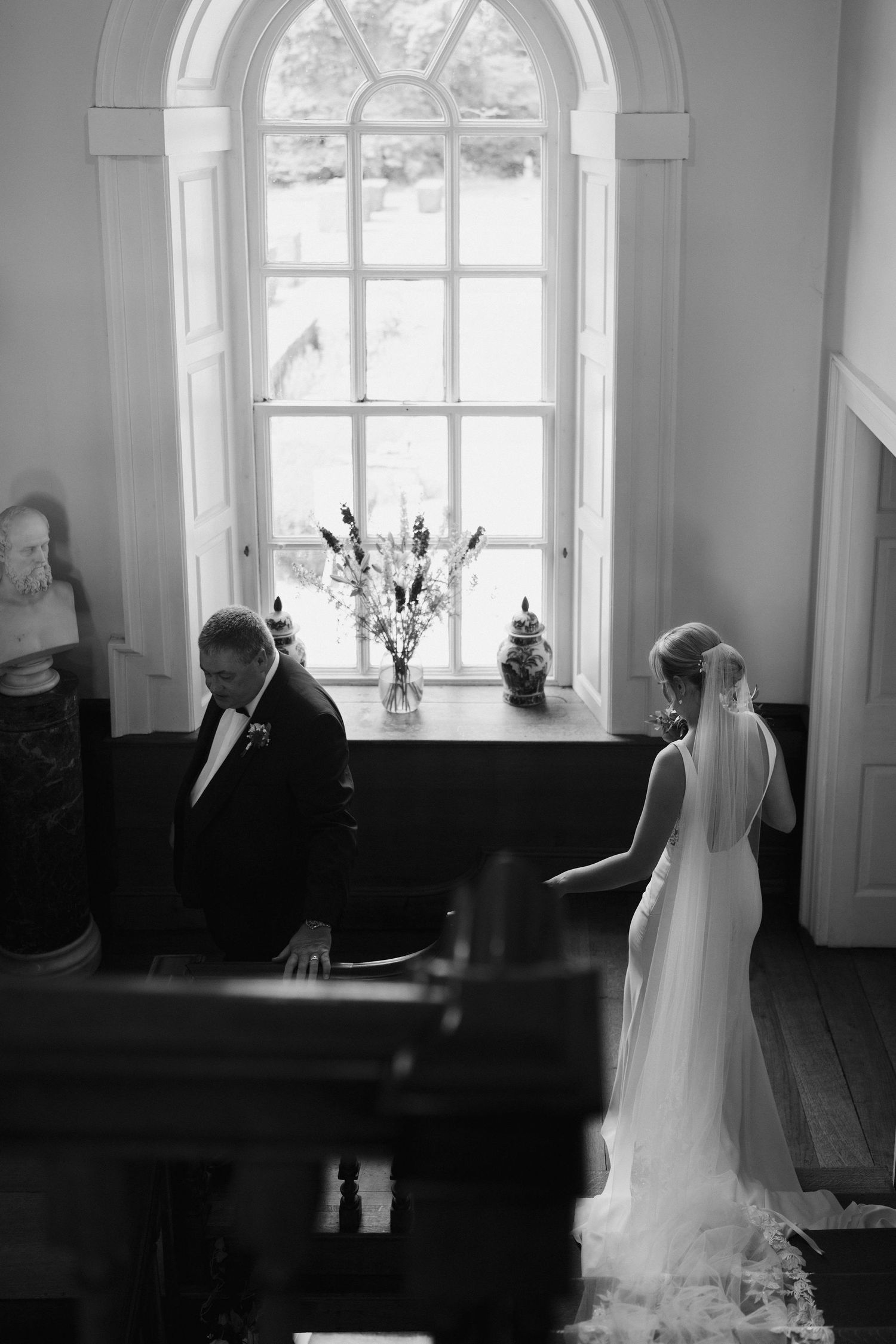 bride and dad descending stairs to the ceremony at Iscoyd park