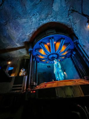 Eerie blue-lit arched doorways create a haunting progression through a dark passageway at night.