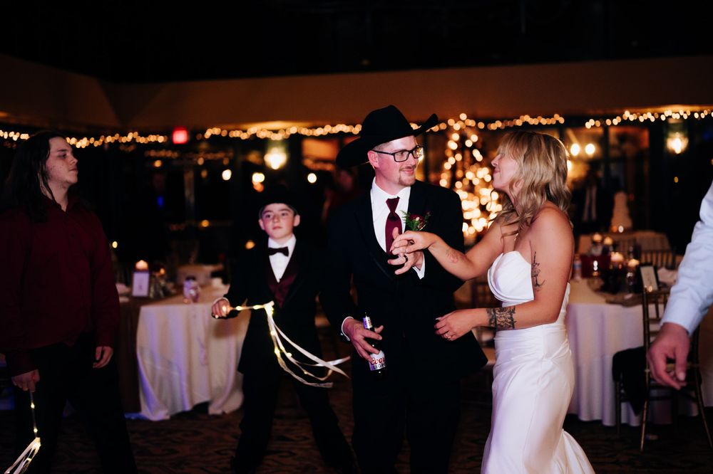Couples dancing together at an elegant evening wedding reception with warm lighting and festive atmosphere.