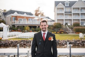 A formal wedding portrait taken outside a coastal resort property.