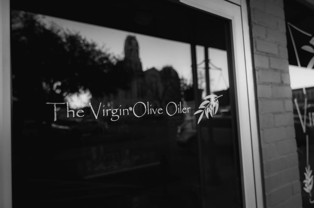 The Virgin Olive Oil storefront exterior with signage visible in the window.