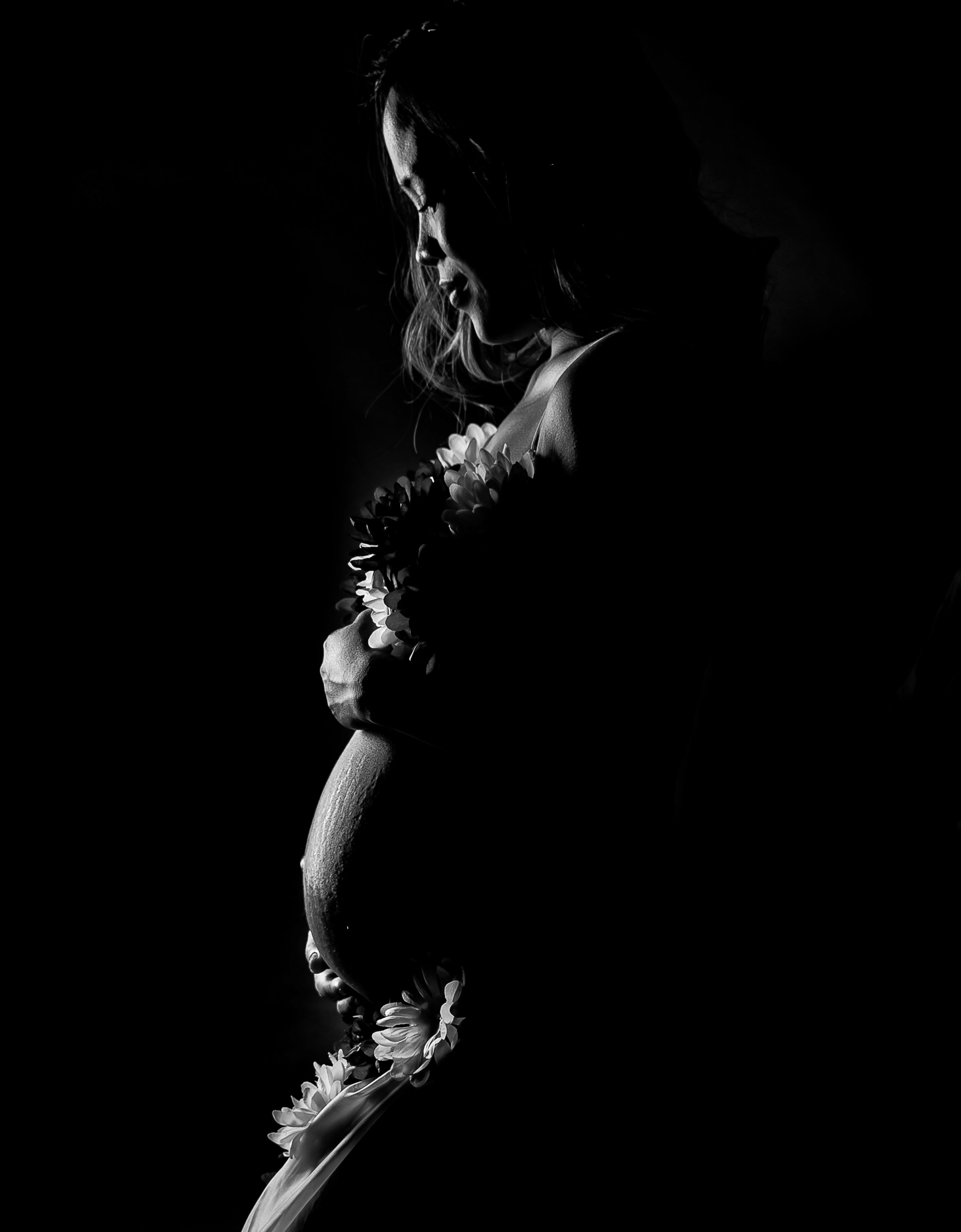 Black and white photograph of a celery stalk in dramatic lighting against a dark background.