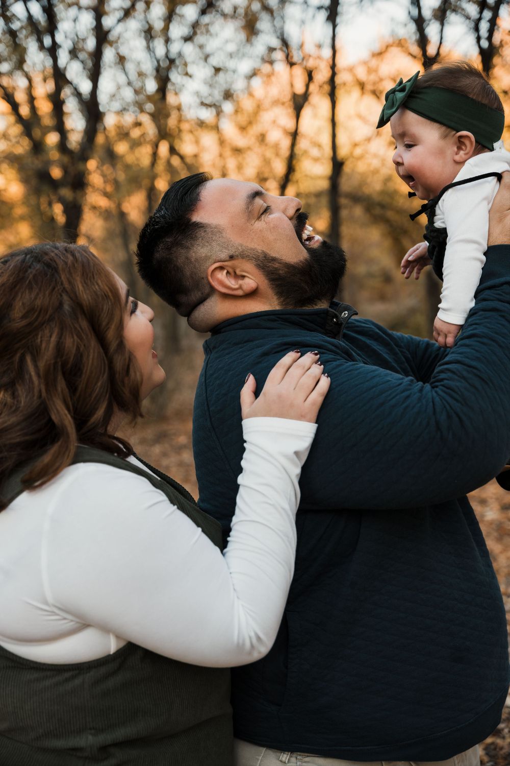 Intimate family portraits showing playful interactions in warm autumn lighting.