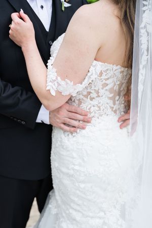 Close up of hands while couple is hugging