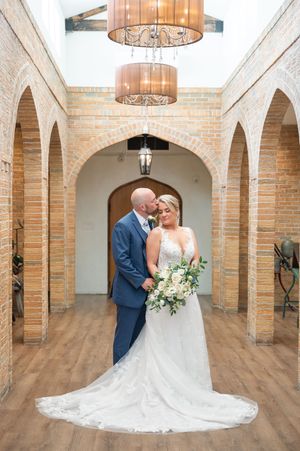 Bride and Groom in brick room in prom pose.