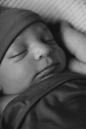 Black and white close up of baby sleeping.