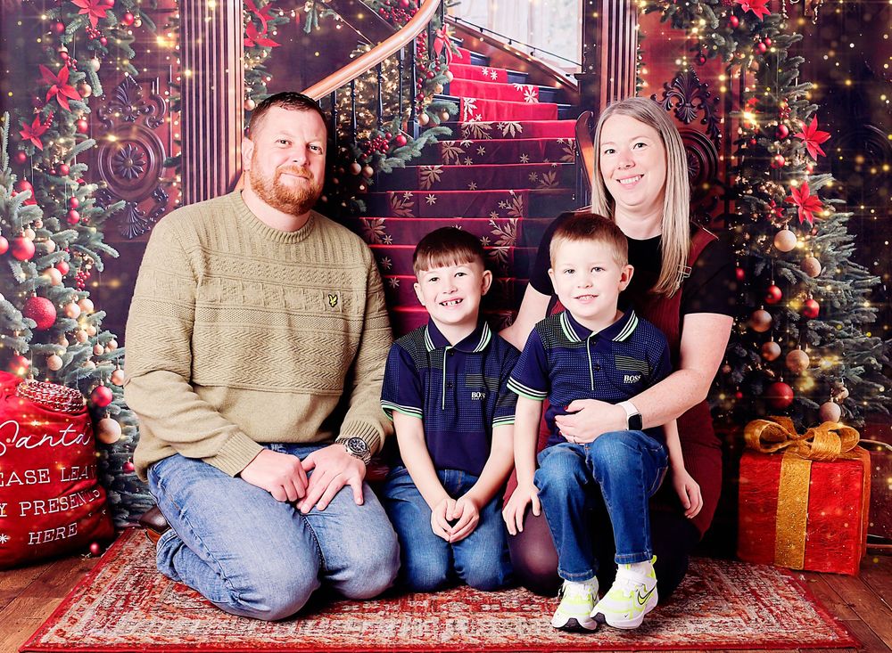 Christmas family photography by Nicola in Woodside, warm and cosy studio portrait capturing love, connection and timeless festive moments.