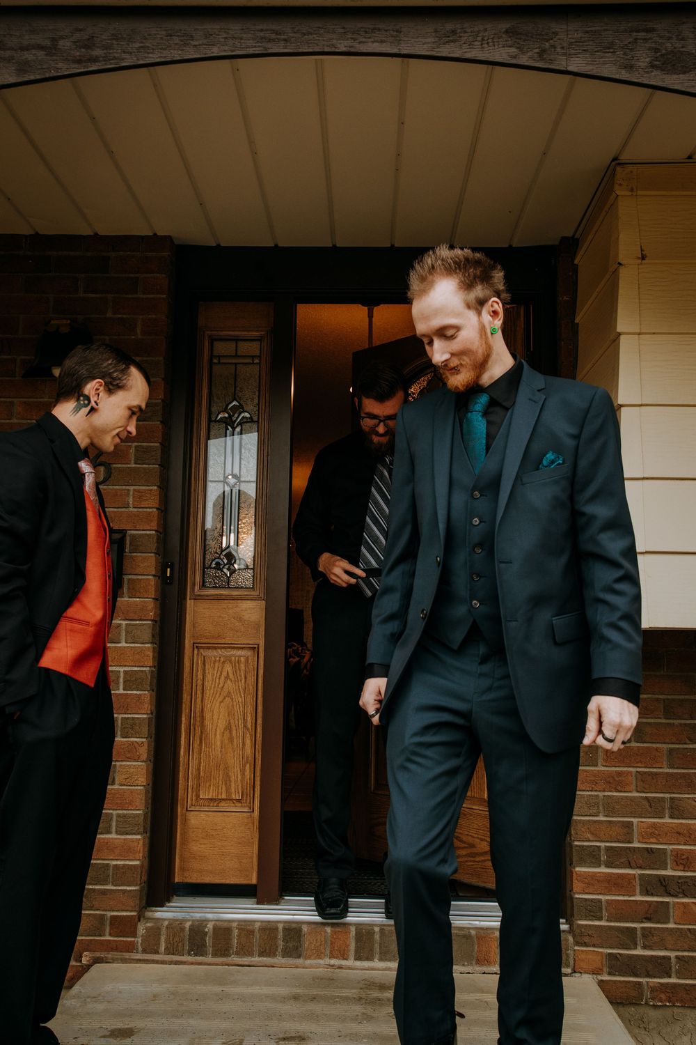 A sequence of candid moments showing people in formal dark attire interacting on a brick porch.