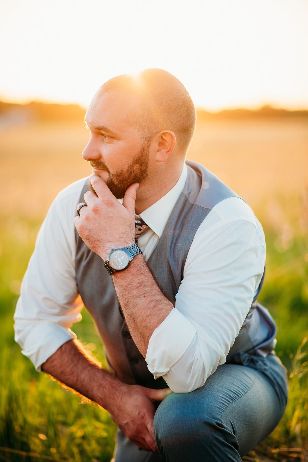 A thoughtful moment captured during a golden hour photoshoot in a field.