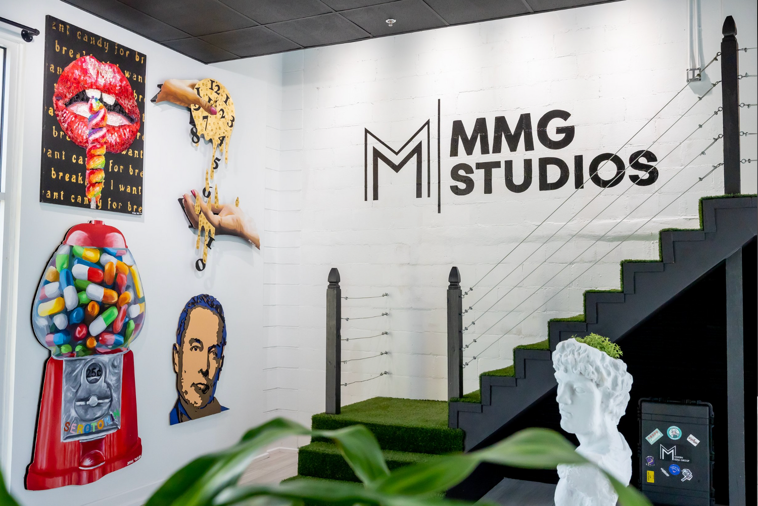 Creative studio space with MMG Studios logo and colorful wall decorations.